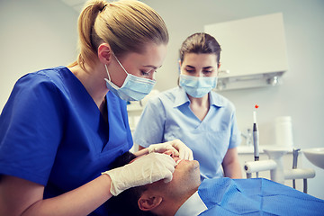 Image showing female dentist checking patient dental occlusion