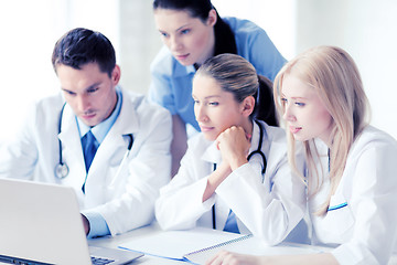 Image showing group of doctors looking at tablet pc