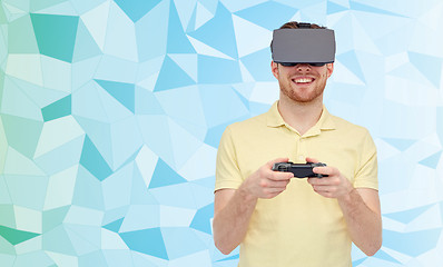 Image showing happy man in virtual reality headset with gamepad