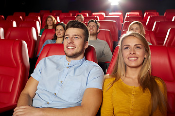 Image showing happy friends watching movie in theater