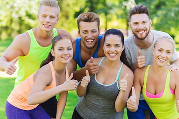 Image showing group of happy sporty friends showing thumbs up