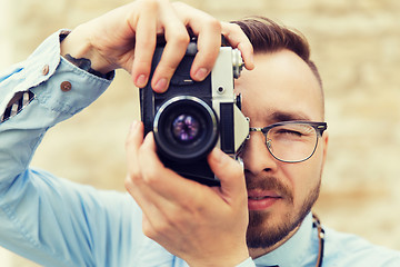 Image showing young hipster man with film camera in city