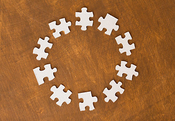 Image showing close up of puzzle pieces on wooden surface