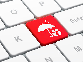 Image showing Protection concept: Family And Umbrella on computer keyboard background