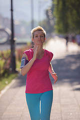 Image showing sporty woman running  on sidewalk