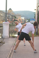 Image showing couple warming up before jogging