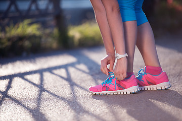 Image showing Closeup of woman tying running shoe