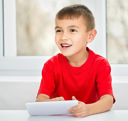 Image showing Young boy is using tablet