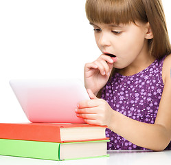 Image showing Young girl is using tablet while studying