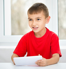 Image showing Young boy is using tablet