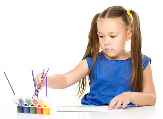 Image showing Little girl is drawing using pencils