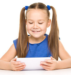 Image showing Young girl is using tablet