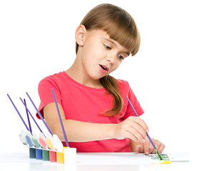 Image showing Little girl is painting with gouache