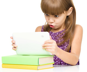 Image showing Young girl is using tablet