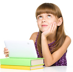 Image showing Young girl is using tablet