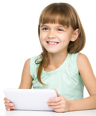 Image showing Young girl is using tablet