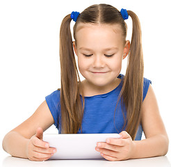 Image showing Young girl is using tablet