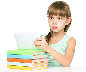 Image showing Young girl is using tablet