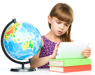 Image showing Young girl is using tablet