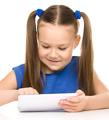 Image showing Young cheerful girl is using tablet