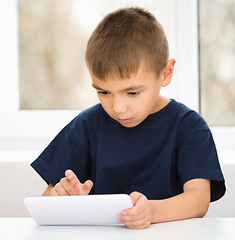 Image showing Young boy is using tablet