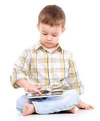 Image showing Young boy is using tablet