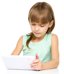 Image showing Young girl is using tablet