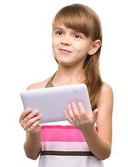 Image showing Young girl is using tablet