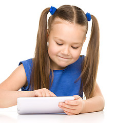 Image showing Young cheerful girl is using tablet