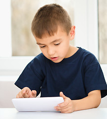 Image showing Young boy is using tablet