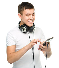 Image showing Young man enjoying music using headphones