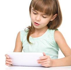 Image showing Young girl is using tablet