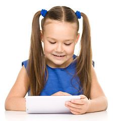 Image showing Young girl is using tablet