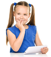 Image showing Young girl is using tablet