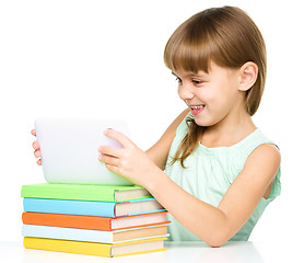 Image showing Young girl is using tablet