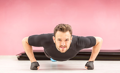 Image showing Portrait of a Young Man Doing Pushups