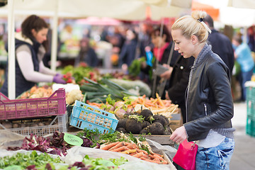 Image showing Woman buying vegetable at local food market. 