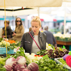 Image showing Woman buying vegetable at local food market. 