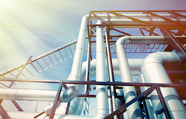 Image showing Industrial zone, Steel pipelines and valves against blue sky