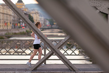 Image showing sporty woman running  on sidewalk