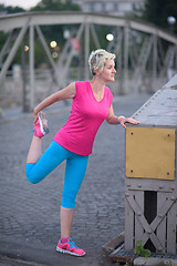 Image showing blonde woman  stretching before morning jogging