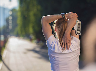 Image showing blonde woman  stretching before morning jogging