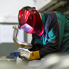 Image showing Industrial worker welding in metal factory.