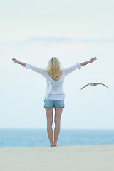 Image showing Free woman enjoying freedom on beach at dusk.