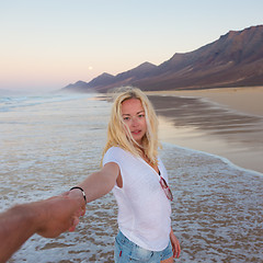 Image showing Romantic couple holding hands on beach.