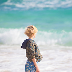 Image showing Boy playing with toys on beach.