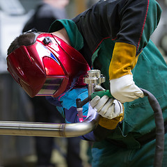 Image showing Industrial worker welding in metal factory.