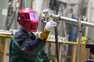 Image showing Industrial worker welding in metal factory.