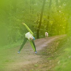 Image showing Sporty woman  working out in forest. 