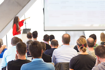 Image showing Female speeker having talk at public event.